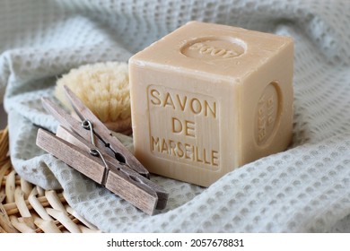 Quimper, Brittany France November 10 2021: Marseille soap or Savon de Marseille on the cotton towel with two clothes pegs - Traditional french pure hard soap  chemical free, used for laundry washing. 