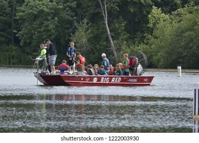 Quincy, Wisconsin / USA - July 25, 2013: An Airboat Full Of People Some Doing Bow And Arrow Fishing On A Quiet Bay Along The Castle Rock Lake. 