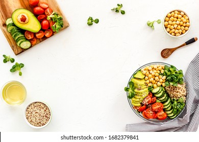 Quinoa, Avocado And Chickpeas In Bowl In Hands - Balanced Healthy Food - On White Table. Top View Copy Space