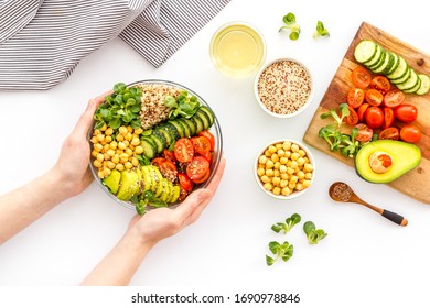 Quinoa, Avocado And Chickpeas In Bowl In Hands - Balanced Healthy Food - On White Table. Top View