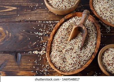 Quinoa in bowl on brown background