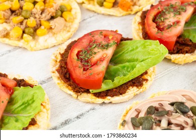 Quinoa Crackers With Olive And Sundried Tomatoes Paste, Tuna Fish And Vegetables On Gray Wooden Background.