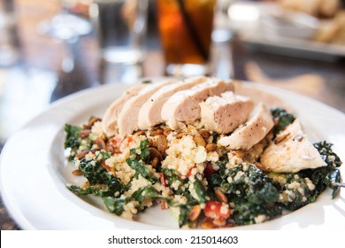 Quinoa And Kale Salad Topped With Sliced Chicken Breast