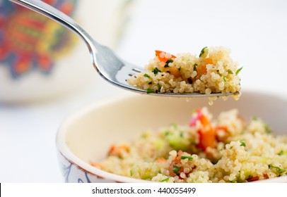 quinoa salad close up in a white bowl 