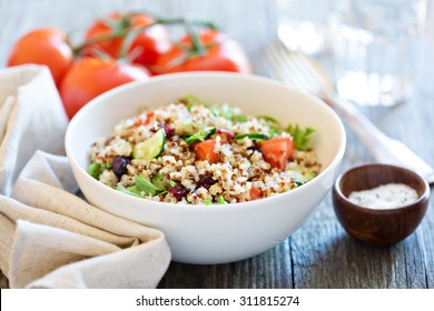 Quinoa salad with fresh tomatoes, cucumbers and salad leaves - Powered by Shutterstock