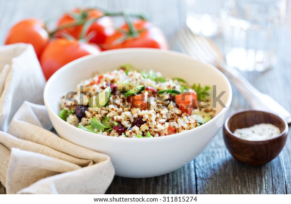 Quinoa salad with fresh tomatoes, cucumbers and\
salad leaves