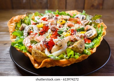 Quinoa Seafood Salad, Mix seafood on a bed of fresh lettuce salad, roasted pepper and mushroom, with sweet chili dressing - Powered by Shutterstock