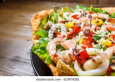 Quinoa Seafood Salad, Mix seafood on a bed of fresh lettuce salad, roasted pepper and mushroom, with sweet chili dressing - Powered by Shutterstock