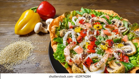 Quinoa Seafood Salad, Mix seafood on a bed of fresh lettuce salad, roasted pepper and mushroom, with sweet chili dressing - Powered by Shutterstock