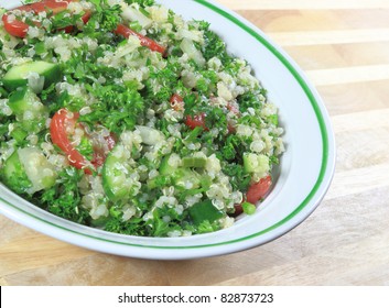 Quinoa Tabouleh Salad In A Bowl Sitting On A Wooden Table.