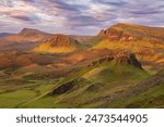 Quiraing, Isle of Skye, Scotland, UK. A calm morning with sunrise colours casting a beautiful soft light on the impressive Trotternish Ridge.