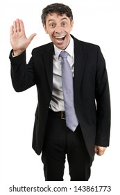 Quirky businessman with an animated expression and mouth open waving hello with the palm of his hand isolated on white - Shutterstock ID 143861773