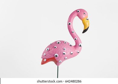 quirky and freak pink plastic flamingo on a pink background with numerous eyesgradient and tones on tones