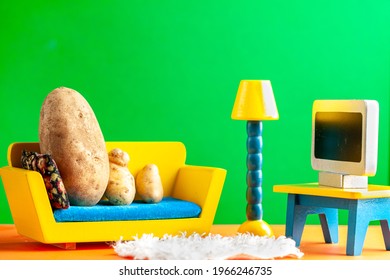 A Quirky Metaphorical Concept Image Showing A Potato Family Lying On A Couch Watching Tv In A Living Room Setting. Image For Being Couch Potato, Obesity, Sedentary Lifestyle And Health Effects.