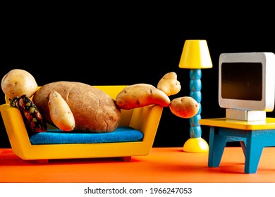 A Quirky Metaphorical Concept Image Showing A Potato Man Lying On A Couch Watching Tv In A Living Room Setting. Image For Being Couch Potato, Obesity, Sedentary Lifestyle And Health Effects.