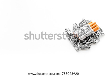 Quit smoking. Cigarettes in chains on white background top view copyspace