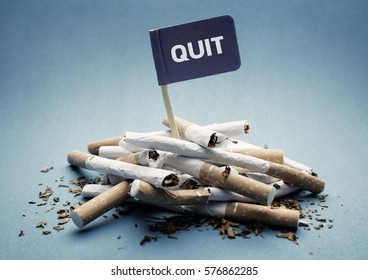 Quit Or Stop Smoking Concept Pile Of Damaged Cigarettes With Sign