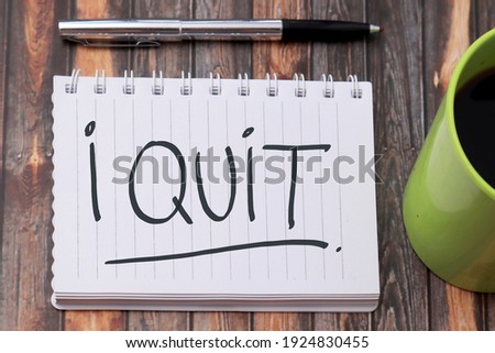 I Quit, text words typography written on book against wooden background, life and business motivational inspirational concept