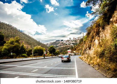 QUITO, ECUADOR - 17 AUGUST 2019: Avenue Simón Bolívar, Which Connects The City Of Quito With Its Surroundings, The Stretch Of The Avenue Has A View Of A Mountain, A Blue Sky And Cars That Move Over It