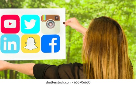 Quito, Ecuador - March 11, 2016: Happy Woman Holding A Printed Stickers Of Facebook, Youtube, Snapchat, Twitter, Instagram And Linkedin Icons, The Most Used Aplication In The World With Both Hands In