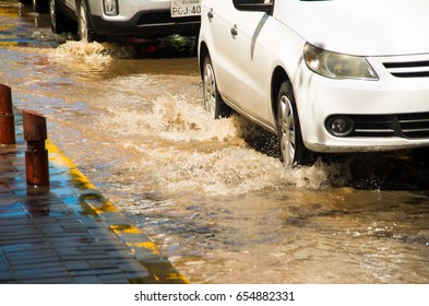 QUITO, ECUADOR - SEPTEMBER 20, 2016: Close up of a car riding on a flooded road in Quito city - Shutterstock ID 654882331