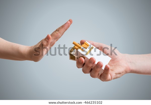 Quitting smoking concept. Hand is refusing cigarette offer.
