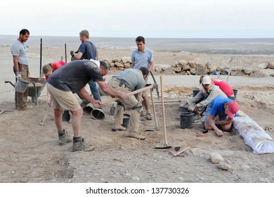 QUMRAN - DEC 14 2008:Archaeologist teamwork in Archeological dig at the caves of Qumran site.The Dead Sea Scrolls were discovered in caves in Qumran near the Dead Sea between the years 1947 and 1956