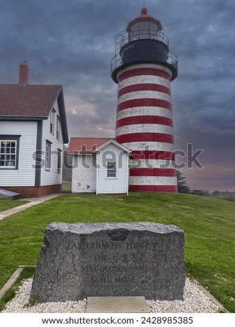 Quoddy Head Lighthouse or West Quoddy Head Light in Lubec, Maine. Quoddy Head State Park. Sign marks the easternmost point of the contiguous United States.