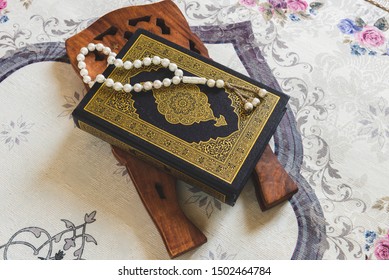 Quran, Beads And Rehal On Prayer Mat. 