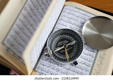 Quran And A  Qibla Compass To Indicate The Direction Of Mecca. Close-Up.  07-30-2018