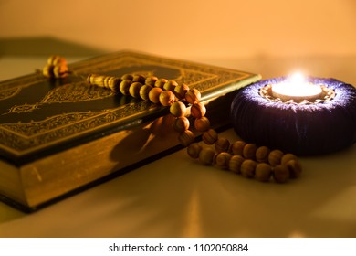 Quran and rosary with soft lantern light for Islamic concept. Holy book for Muslims for Ramadan,blessed Friday message and three months.