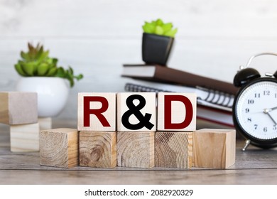 R and D word written on wooden blocks. Sales, business concept