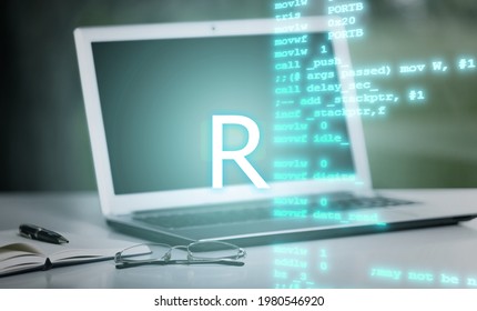 R Programming Language Inscription Against Laptop Computer And Code Background.