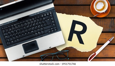 R Programming Language. Letter R On Paper And Laptop