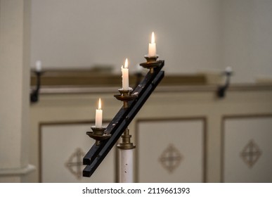 Raasiku Estonia - February 05 2022: Burning Candles In The Row In Small Lutheran Church. Small Light In Dark Chapel During Funeral Ceremony. Raasiku Village, Estonia, Europe.