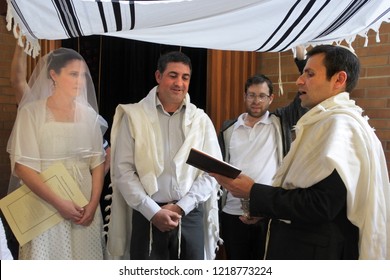 Rabbi Blessing Jewish Bride And A Bridegroom In Modern Orthodox Jewish Wedding Ceremony In Synagog.