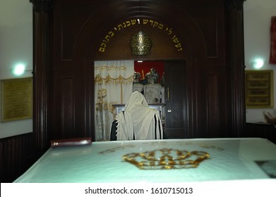 A Rabbi Prays In The Ark Of The Torah With The Torah Scrolls In Synagogue In Israel. (Hebrew Translation: 