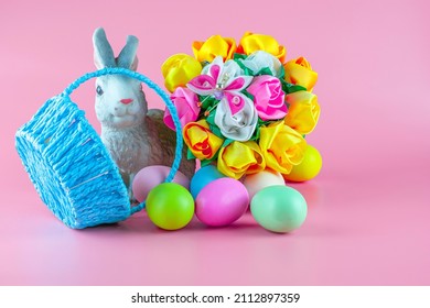 rabbit basket with flowers and inverted basket with easter eggs on pink background copyscape. High quality photo