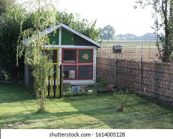 Rabbit hutch with outdoor enclosure in the countryside - Shutterstock ID 1614005128
