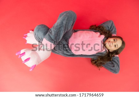 Rabbit totem is symbol of luck. Relaxing on floor top view. Rest and relax. Cute bunny kid. Baby animal character. Girl in bunny costume. Child rabbit kigurumi. Happy girl bunny pajamas. Smiling kid.
