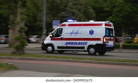 In a race against time, an ambulance van speeds through the city streets, its blue lights flashing, as paramedics rush to provide life-saving assistance.