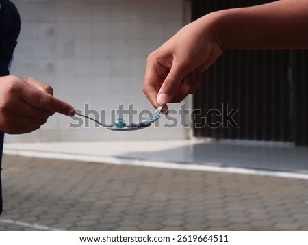 A race by running with marbles using a spoon in a relay