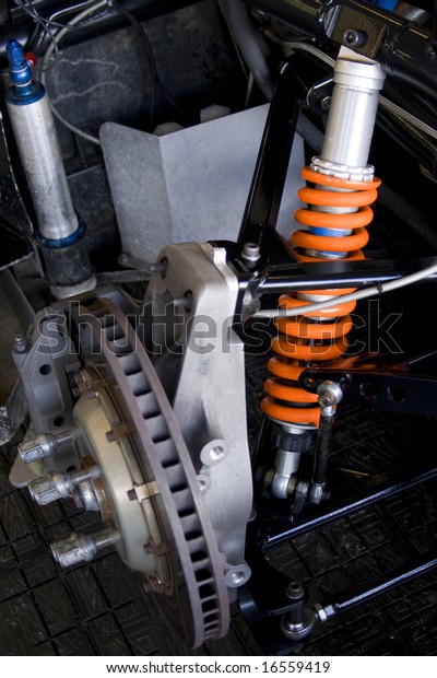 race car brake\
disk and orange shock\
absorber