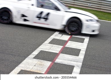 Race Car Crossing The Finish Line On A Circuit