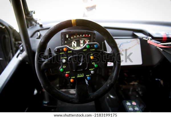 Race car driver point of view inside cockpit,\
steering wheel with knobs and Honda logo. Vallelunga, Italy, july\
24 2022, Race of Italy