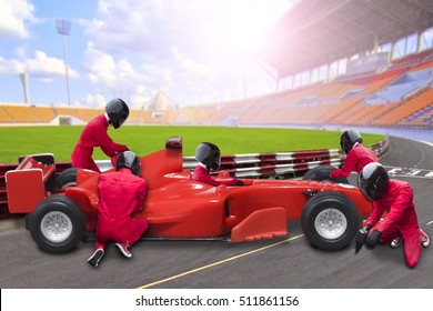 Race Car Driver Posing In Front Of The Pit Stop With Team Maintaining Technical Service For A Racing Car During Competition Event