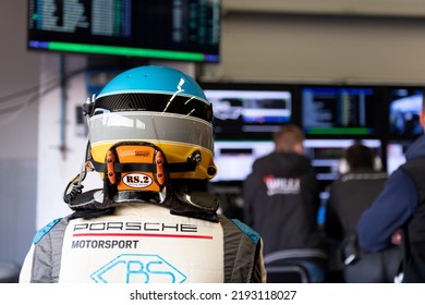 Race Car Driver In Racing Suit Looking At Display Race Info In Team Garage. Mugello, Italy, March 25 2022. 24 Hours Series