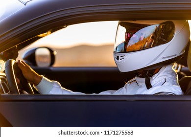 A Race Car Driver At The Wheel