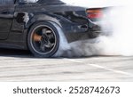 Race drift car burning tires on speed track.