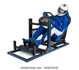 Race Driver In Blue Overall With Helmet Training On Simracing Aluminum Simulator Rig For Video Game Racing. Motorsport Car Bucket Seat Steering Wheel Pedals Isolated On White Background